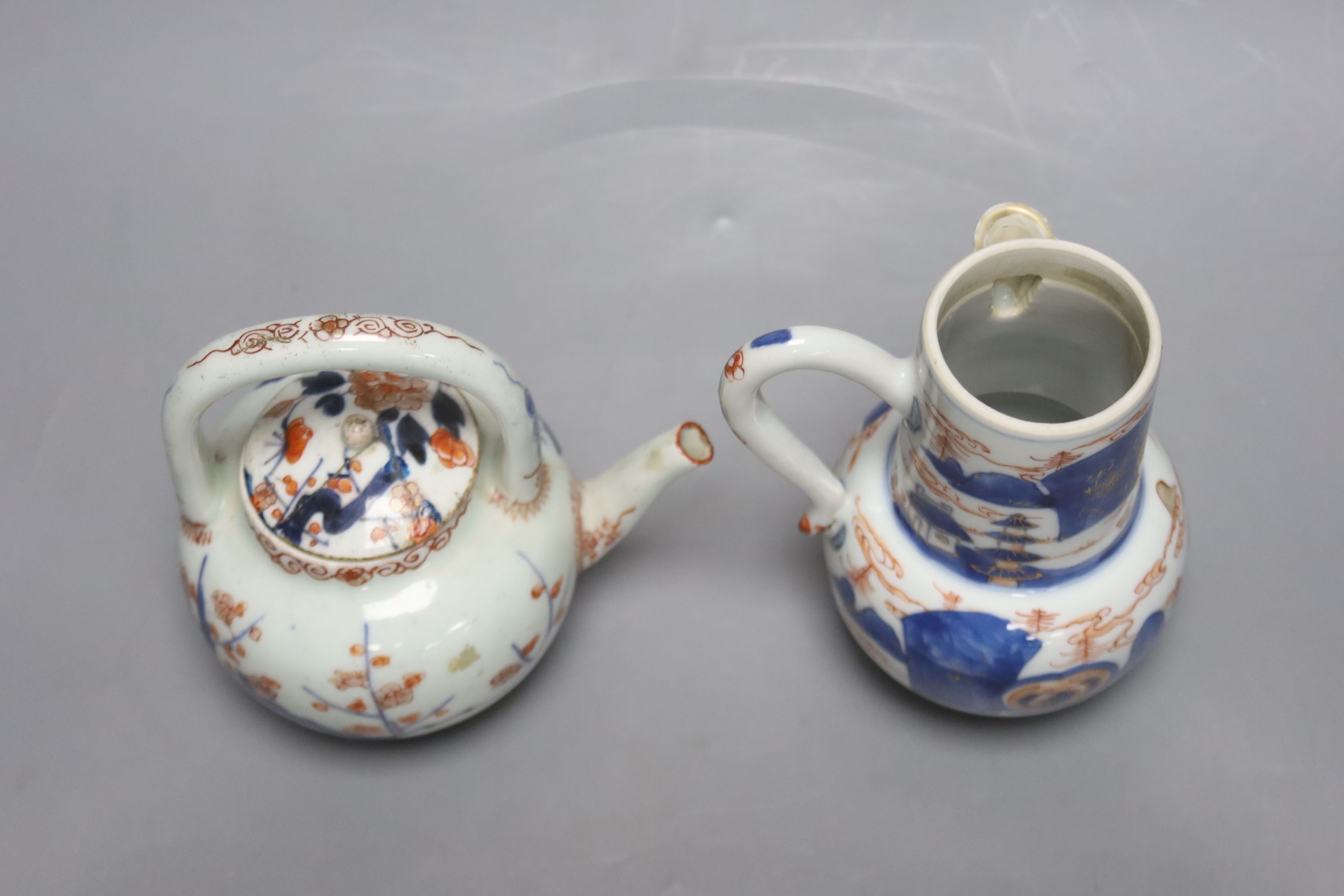 A pair of 18th century Chinese Imari style dishes, diameter 22.5cm, together with a similar chocolate pot and an 18th century Japanese Arita teapot, associated cover